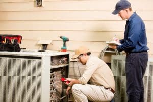 technicians-evaluate-air-conditioning-system