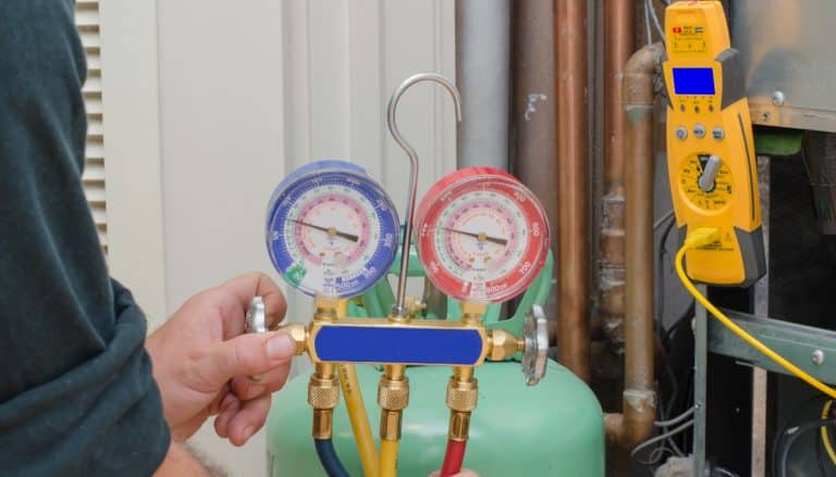freon-check tech holding instrument and reading